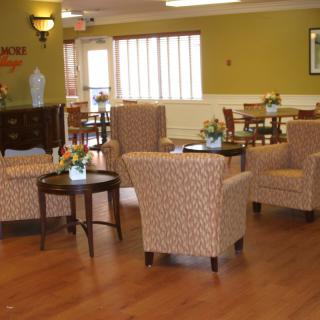 A cozy lounge area with comfortable chairs and small tables.