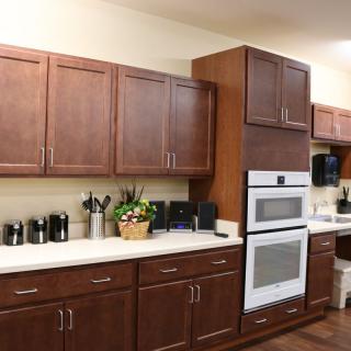 A modern kitchen with wooden cabinets and built-in appliances.