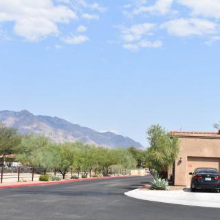 A suburban street with a mountain view and clear skies.