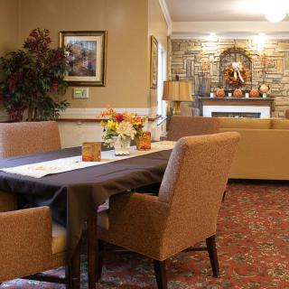 A cozy dining and living area with warm-toned furniture and elegant decor.