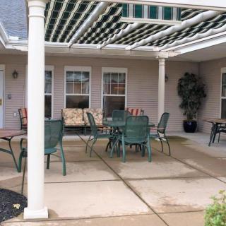 A cozy patio with outdoor furniture under a pergola.
