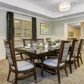 A well-appointed dining room with a large table and elegant chairs.