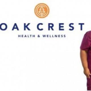 Oak Crest Health & Wellness logo with a person in medical scrubs.
