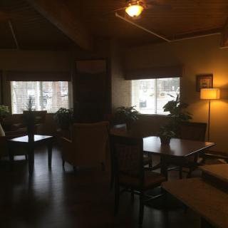 A cozy interior living space with natural light, wooden accents, and a touch of greenery.