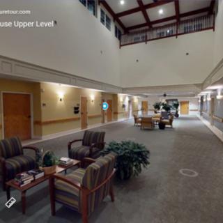 A spacious indoor lobby area with comfortable seating and decorative plants.