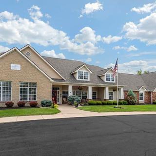 A suburban residential building with a flagpole and a clear sky in the background.