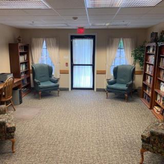 A cozy library interior with comfortable chairs and bookshelves.