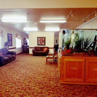A spacious and inviting lounge area featuring comfortable sofas and an aquarium.