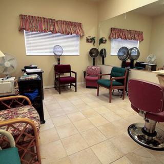 A cozy hair salon with a waiting area and hair dryers.