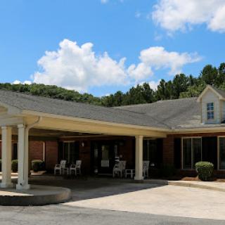 A charming residential building with a welcoming entrance under a blue sky.