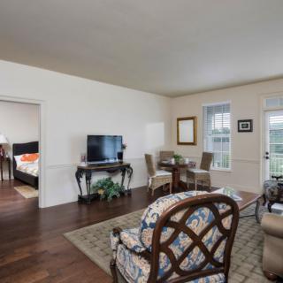 Spacious living room with a dining area and elegant furnishings.