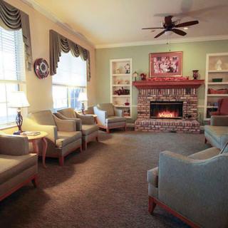 A cozy living room with a fireplace and comfortable seating.