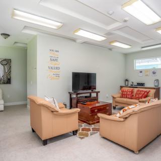 A cozy living room with sofas, a television, and a coffee table.