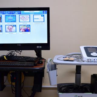 A medical setup featuring a monitor displaying various images alongside an ultrasound machine.