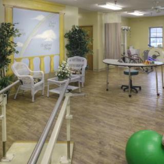 A rehabilitation facility with exercise equipment and seating area for physical therapy.
