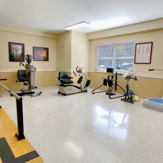 A well-equipped fitness and rehabilitation room with various exercise machines.