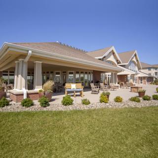 A modern house with a well-maintained lawn and outdoor patio area.