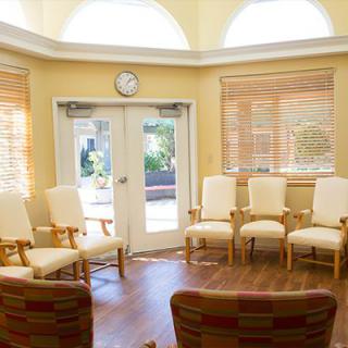 A bright waiting room with arranged chairs and sunlight streaming through the windows.