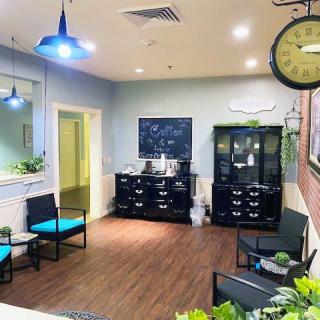 A cozy waiting room with modern decor and comfortable seating.