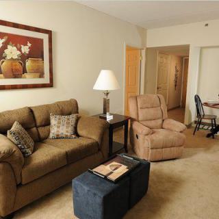 A cozy living room featuring a comfortable sofa, armchair, and tasteful decor.