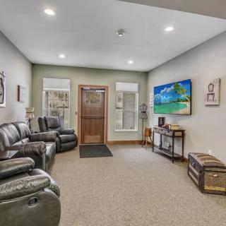A well-furnished living room with comfortable seating and decorative artwork.