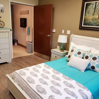 A cozy bedroom with inviting decor and neutral tones.