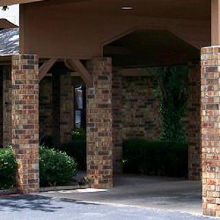 A covered entrance with brick columns and a walkway.