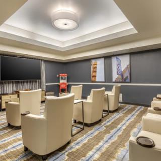 A modern meeting room with comfortable chairs and artwork on the walls.