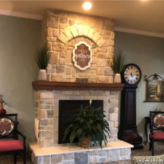 A cozy living room with a stone fireplace and elegant decor.