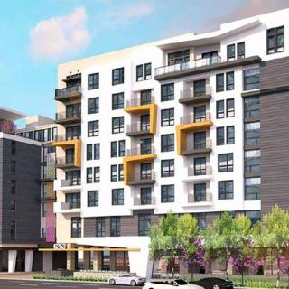A modern apartment building in an urban setting with multiple balconies and landscaped surroundings.