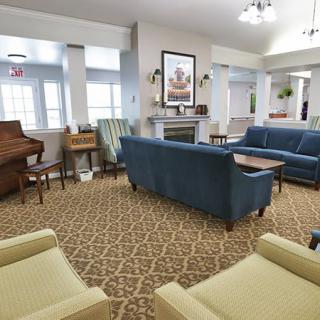 A cozy lobby area with comfortable seating and a piano.