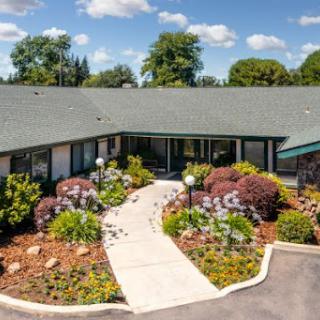 A beautifully landscaped entrance leading to a welcoming building.