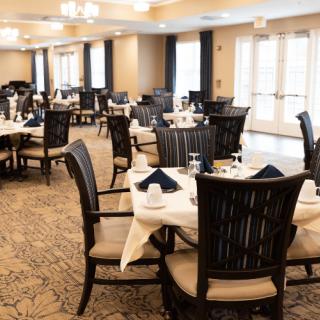 An elegant dining room with neatly arranged tables and chairs, ready for guests.