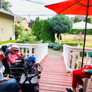 A peaceful afternoon gathering on the patio, enjoying the company and the shade.