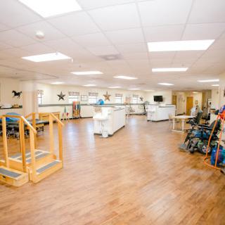 A spacious physical therapy office equipped with various exercise tools for rehabilitation.