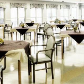 An empty dining area with neatly arranged tables and chairs.