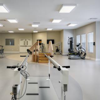 A spacious and well-equipped rehabilitation center designed for physical therapy and exercise.