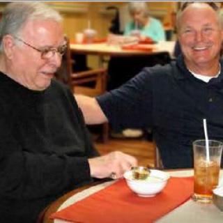 Two men enjoying a meal together at a restaurant.