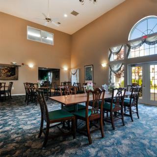A spacious dining area with elegant furniture and large windows.
