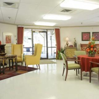 A well-lit room with tables and chairs, featuring decorative elements.