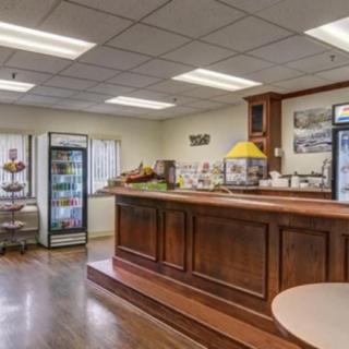 Cozy cafe interior with a wooden counter and food display.