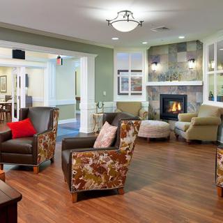 A cozy living room with comfortable seating and a warm fireplace.