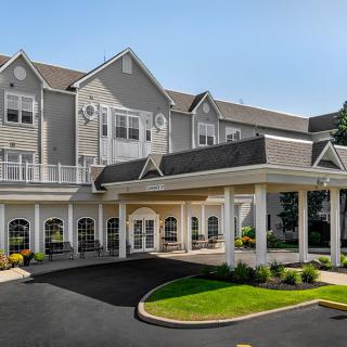 A beautifully designed residential building with a welcoming entrance and well-maintained landscaping.