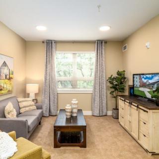 A cozy and well-decorated living room with a comfortable sofa, television, and stylish decor.