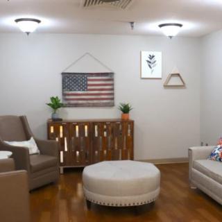 A cozy living room with comfortable seating and American-themed decor.