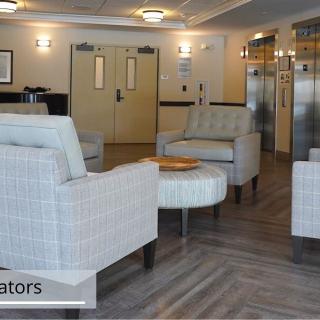 A modern lobby seating area with comfortable chairs and neutral decor.