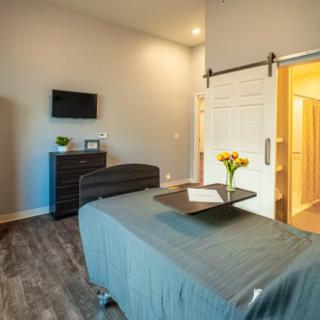 A modern spa room featuring a massage table, soft lighting, and a calming atmosphere.