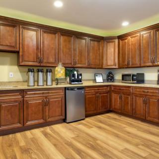 A modern kitchen with wooden cabinets and stainless steel appliances.