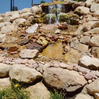 A small waterfall cascading down a rocky landscape.
