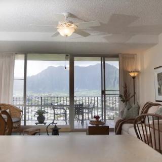 A cozy living room with a stunning mountain view from the balcony.